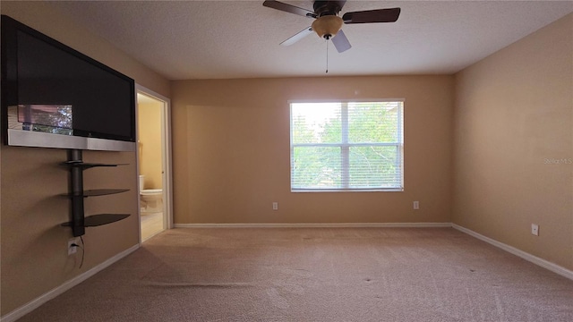 spare room featuring ceiling fan, a textured ceiling, and carpet floors