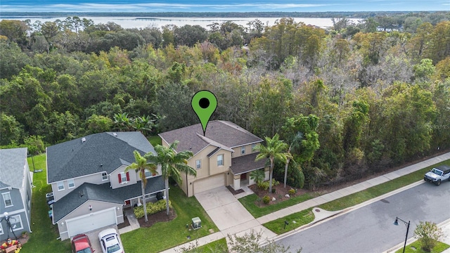 birds eye view of property with a water view