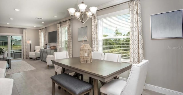 dining space with crown molding, a healthy amount of sunlight, and a chandelier