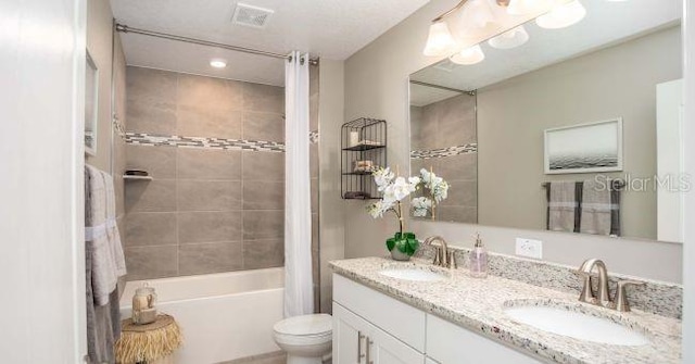 full bathroom featuring vanity, shower / tub combo with curtain, and toilet