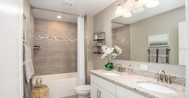 full bathroom with toilet, shower / bath combo with shower curtain, and vanity