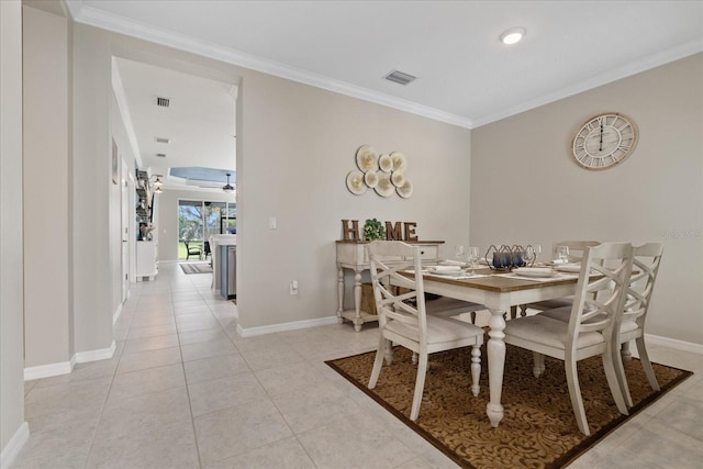 tiled dining area featuring ceiling fan and ornamental molding