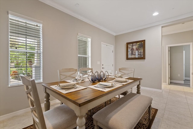 dining space with crown molding, plenty of natural light, and light tile patterned floors