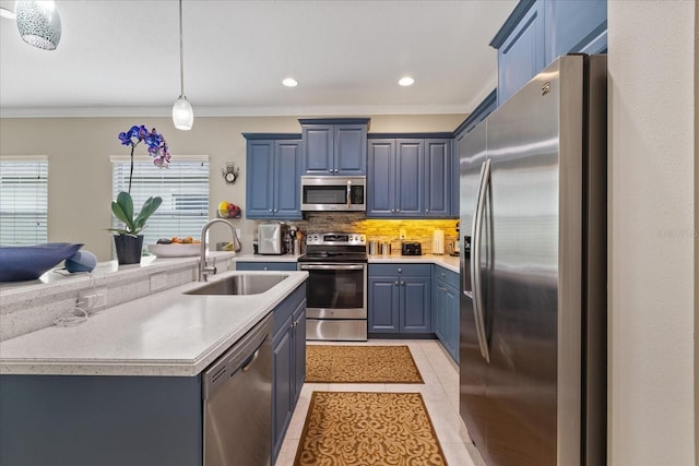 kitchen featuring sink, blue cabinets, light tile patterned flooring, and appliances with stainless steel finishes