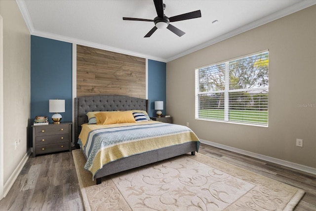 bedroom featuring ceiling fan, wood-type flooring, and ornamental molding