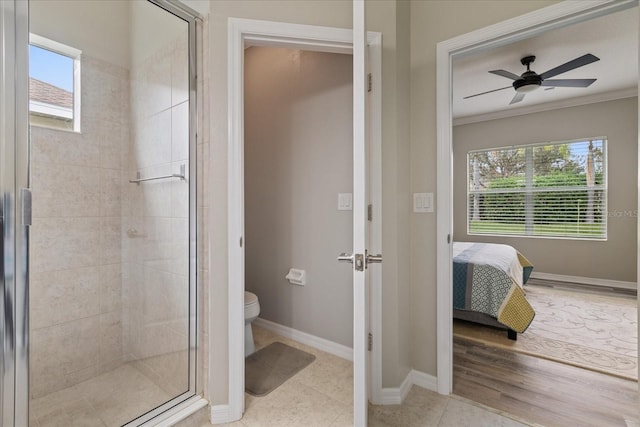 bathroom featuring tile patterned floors, ceiling fan, crown molding, toilet, and a shower with shower door