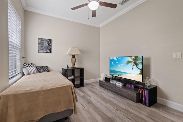 bedroom with light hardwood / wood-style flooring, ceiling fan, and ornamental molding