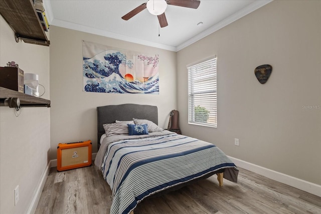 bedroom featuring light hardwood / wood-style flooring, ceiling fan, and crown molding