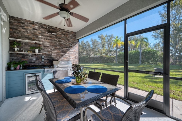 sunroom featuring wine cooler and ceiling fan