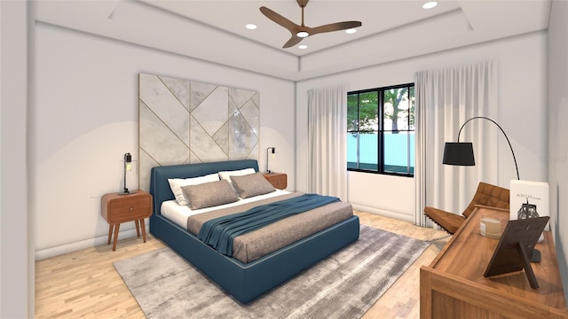 bedroom featuring hardwood / wood-style floors, ceiling fan, and a tray ceiling