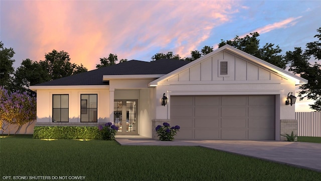 view of front of property with a yard, a garage, and french doors