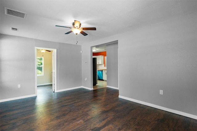 spare room with dark wood-type flooring and ceiling fan