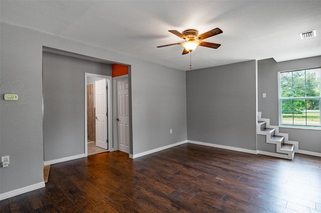 unfurnished room featuring dark wood-type flooring and ceiling fan