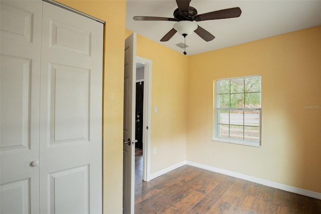 empty room featuring ceiling fan and dark hardwood / wood-style floors