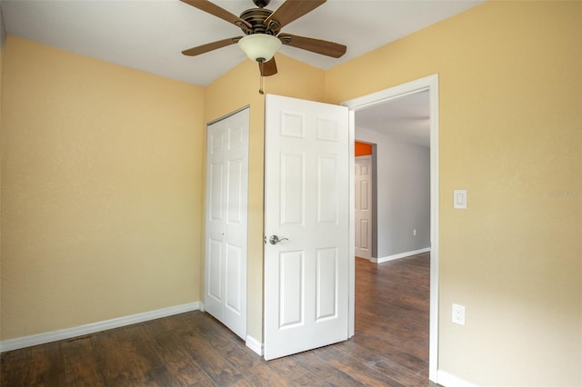 unfurnished bedroom with ceiling fan and dark hardwood / wood-style floors