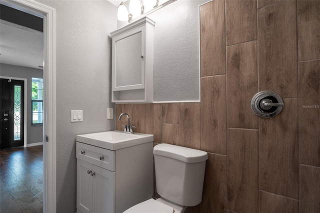 bathroom featuring hardwood / wood-style flooring, vanity, and toilet