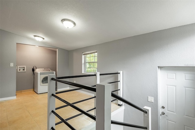 stairs with washer / clothes dryer and a textured ceiling