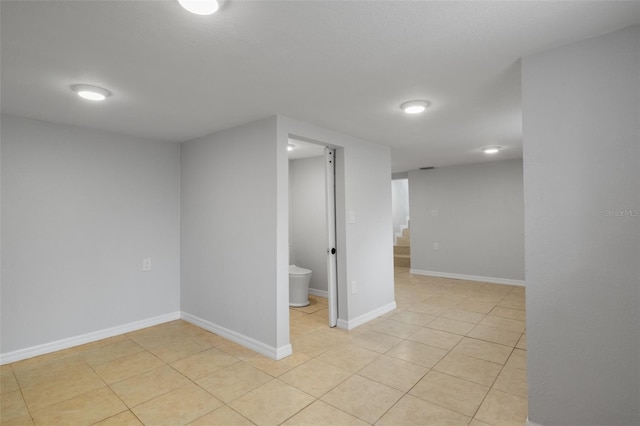 basement featuring light tile patterned floors