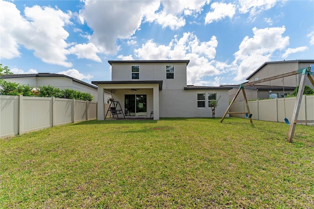 rear view of house with a yard and a patio area