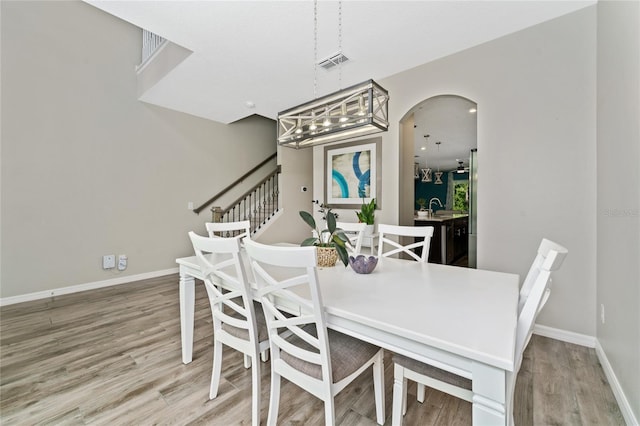 dining room featuring hardwood / wood-style flooring and sink