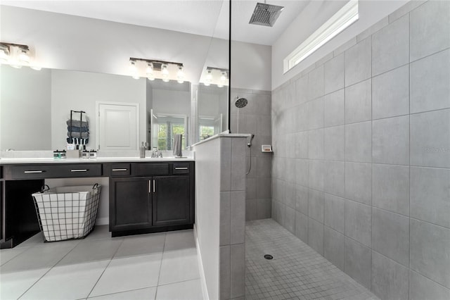 bathroom featuring vanity, tile patterned floors, and tiled shower