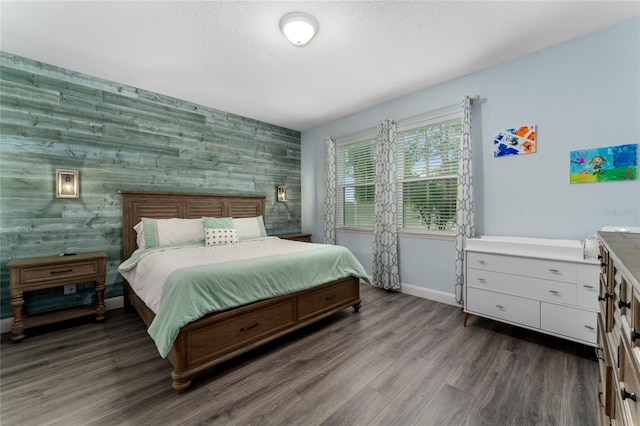 bedroom with dark hardwood / wood-style floors