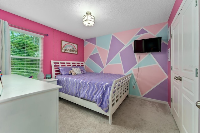 bedroom with light carpet and a textured ceiling