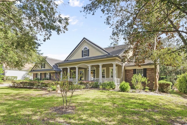 view of front facade with a front yard and a porch