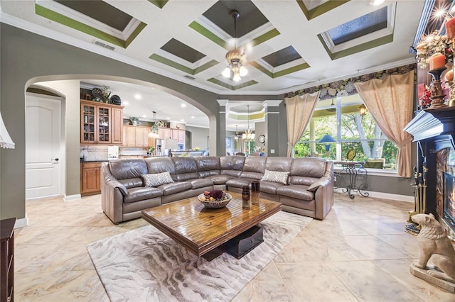 living room featuring crown molding, ceiling fan with notable chandelier, and coffered ceiling