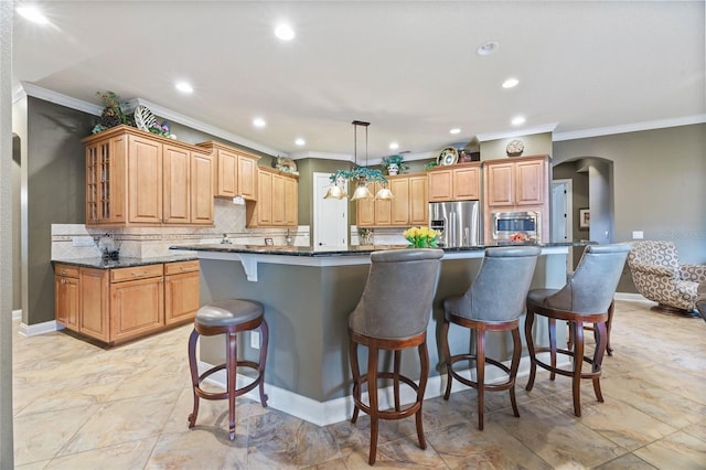 kitchen featuring stainless steel appliances, a large island, pendant lighting, and dark stone counters