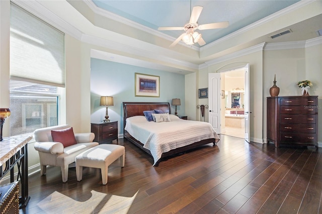 bedroom featuring ensuite bath, ceiling fan, a raised ceiling, dark hardwood / wood-style flooring, and ornamental molding