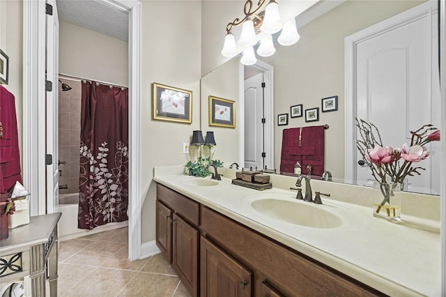 bathroom featuring shower / bath combo, a textured ceiling, vanity, tile patterned flooring, and a chandelier