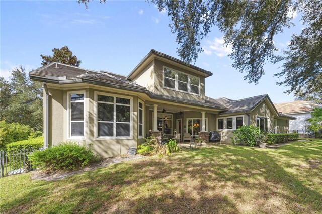 rear view of property with a lawn