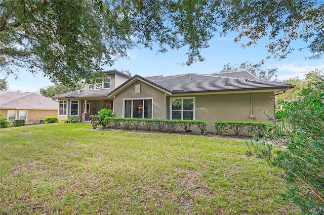 rear view of house with a yard