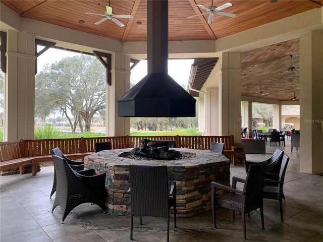 sunroom / solarium with wood ceiling, a wealth of natural light, and vaulted ceiling