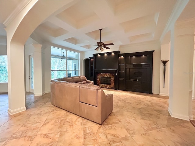 living room featuring beam ceiling, ceiling fan, a fireplace, and coffered ceiling