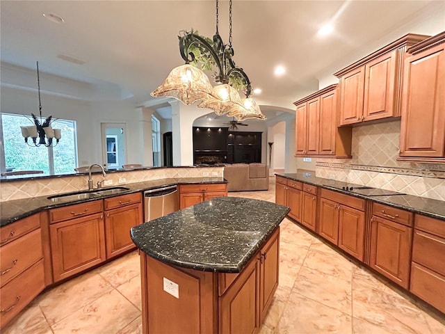 kitchen with sink, a center island, an inviting chandelier, stainless steel dishwasher, and black electric stovetop