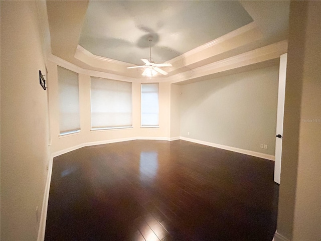 unfurnished room with wood-type flooring, a raised ceiling, and ceiling fan