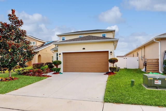 view of front of property with a garage and a front lawn