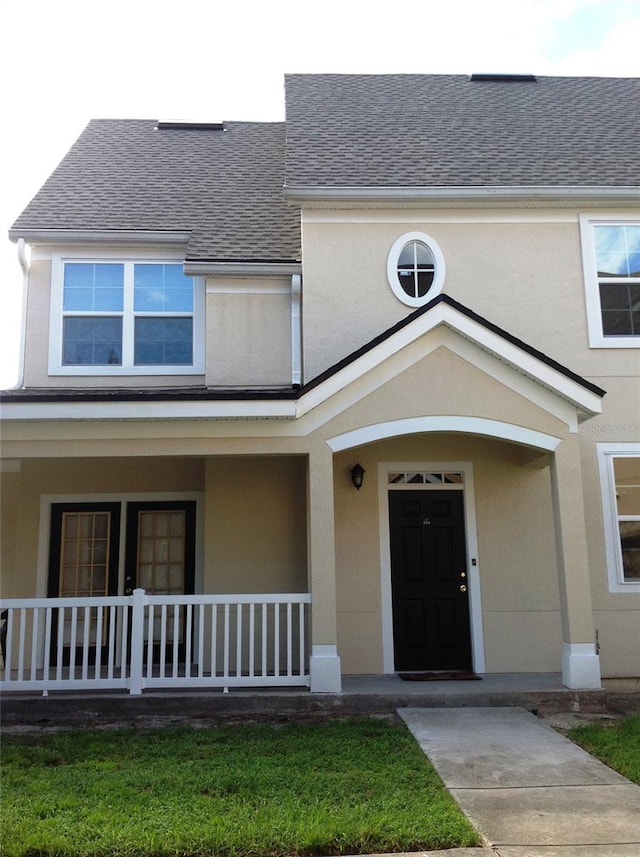 view of front of property with a front yard and a porch