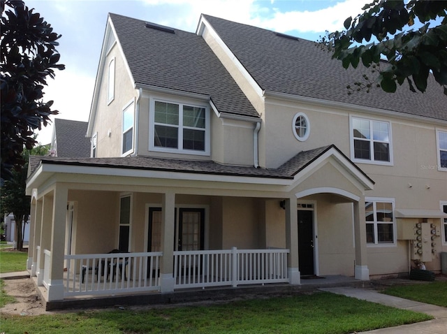 view of front of home featuring a front yard and a porch