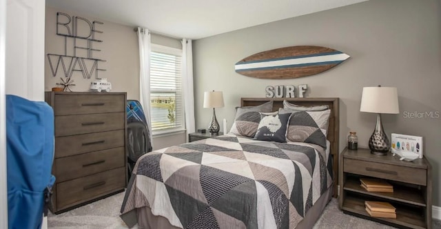 bedroom featuring light colored carpet