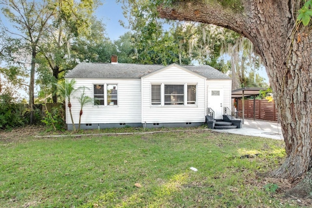 back of property featuring a patio area and a lawn