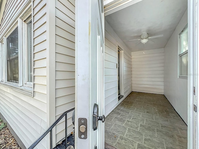 property entrance featuring a patio area and ceiling fan