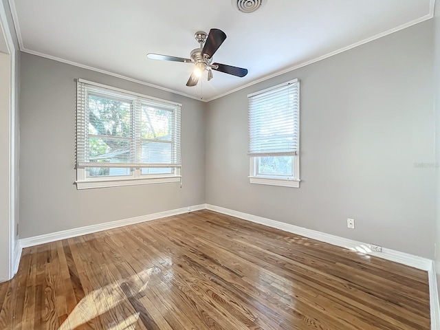 unfurnished room featuring hardwood / wood-style floors, crown molding, and ceiling fan