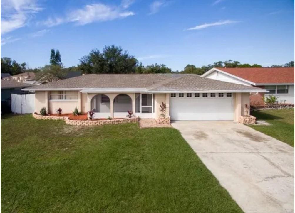 ranch-style home featuring a front yard and a garage