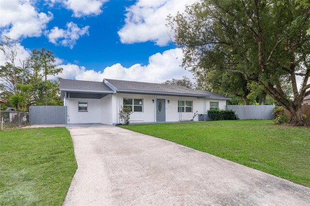 3703 Wade Rd, Orlando, FL 32808 - ranch-style house featuring concrete driveway, an attached carport, stucco siding, and a shingled roof