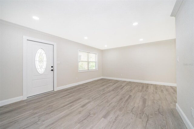 3703 Wade Rd, Orlando, FL 32808 - entrance foyer with ornamental molding, light wood-style floors, baseboards, and recessed lighting