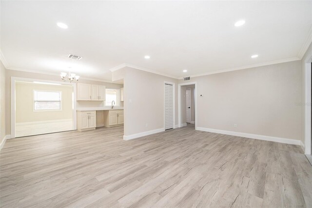 3703 Wade Rd, Orlando, FL 32808 - unfurnished living room with a chandelier, ornamental molding, light wood finished floors, recessed lighting, and baseboards