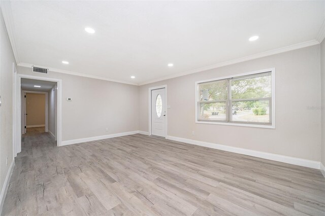 3703 Wade Rd, Orlando, FL 32808 - unfurnished living room featuring baseboards, light wood-style floors, ornamental molding, and recessed lighting